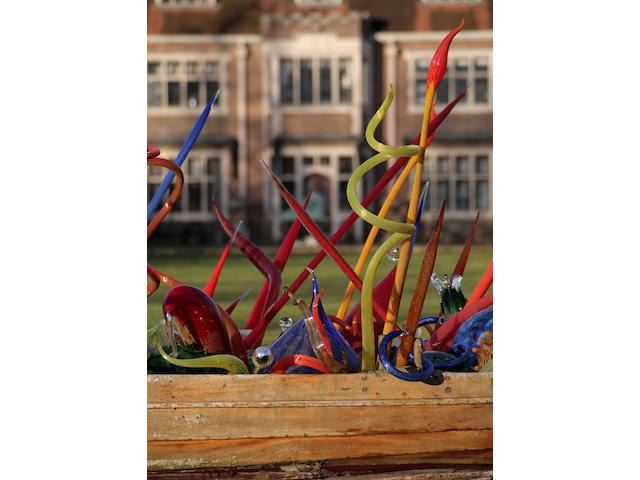 Dale Chihuly (American, born 1941) The Thames Skiff, 2002 Chihuly Studio number '02.2540.in'blown glass, wooden boatincluding multi-colored Ikebana, Reeds, and Nijima Floats 700cm wide x 200cm deep x 240cm high (275in wide x 79in deep x 94.5in high)
