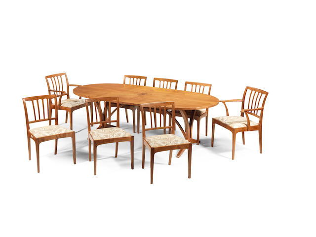 Edward Barnsley (British, 1900-1987): A dining table and eight chairs, Executed 1977/1978 English walnut with sycamore cross-banding,  73cm high, 228cm wide (28 3/4in high, 89 3/4in wide)