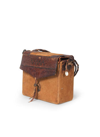 A Qur'an in a hide carrying-case Sub-Saharan Africa, probably Sudan, circa 1900