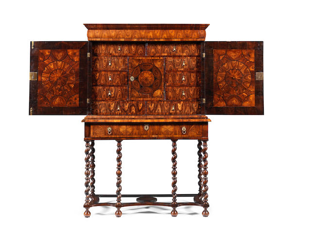 A William and Mary kingwood, oyster veneered and ebony inlaid cabinet on a later stand Circa 1690, the cabinet in the manner of Thomas Pistor