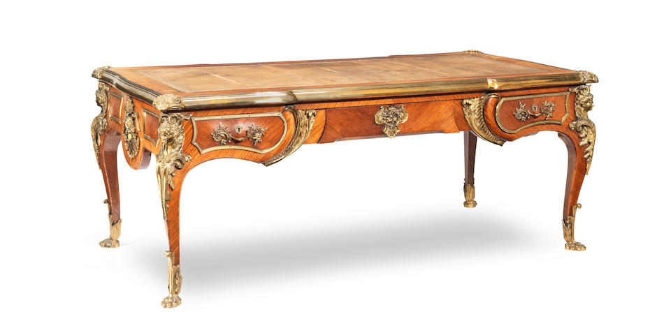A French late 19th century gilt bronze mounted kingwood bureau plat after Charles Cressent