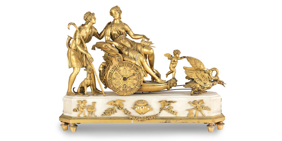 An early 19th century French ormolu-mounted white marble mantel timepiece  The base with an applied pair of ormolu love-struck hearts engraved with the initials VS and AD