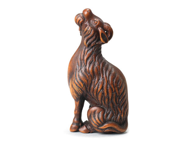 A wood netsuke of a goat By Tomotada, Kyoto, late 18th/early 19th century