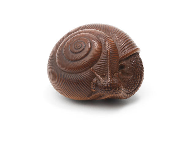 A fine wood netsuke of a snail  By Naito Toyomasa (1773-1856), Tanba Province, Edo period (1615-1868), early-mid 19th century