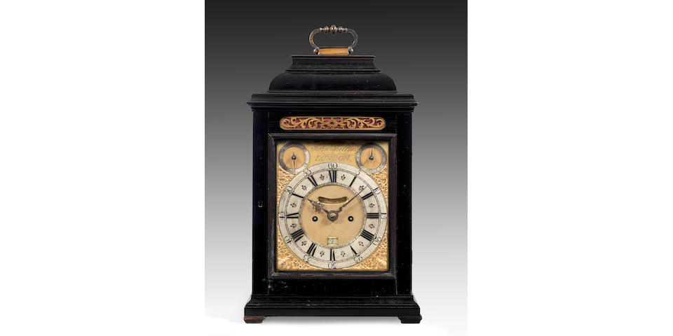 A fine and very rare first half of the 18th century ebony veneered table clock. Together with the original double ended crank key.  John Shelton, London