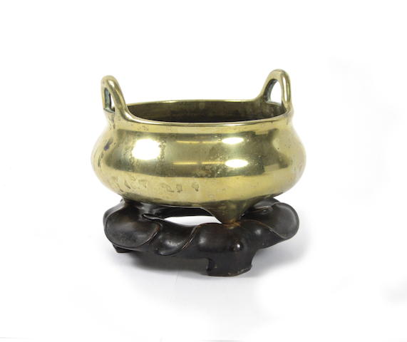 A bronze tripod incense burner on hardwood stand Six character Xuande mark but later