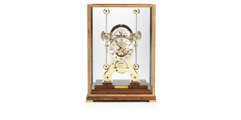 A contemporary 'NAVIGATOR' brass and walnut mouted Skelton Clock mantel clock Engraved Comitti England and bearing trade label for Asprey
