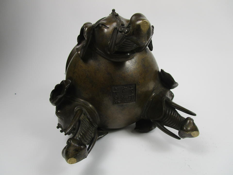 A large and impressive bronze tripod incense burner on wood stand Well defined Xuande six-character mark but 19th century (2)