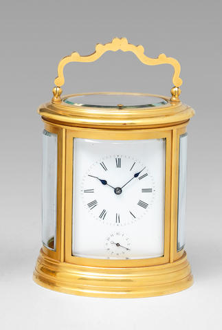 A good late 19th century French gilt brass oval grande-sonnerie striking and repeating carriage clock in original box  The movement numbered 713. 2