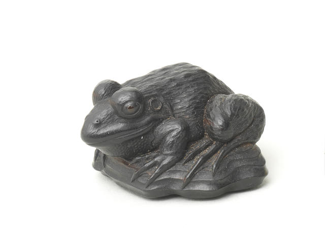 An ebony netsuke of a frog on driftwood Attributed to Seiyodo Tomiharu (1733-1810), Iwami Province, late 18th/early 19th century