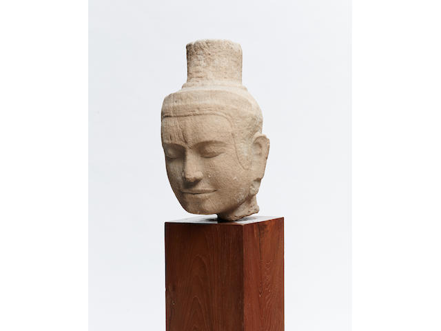 A BUFF SANDSTONE HEAD, AVALOKITESVARA OR SHIVA Khmer, Bayon Period, late 12th/early 13th century