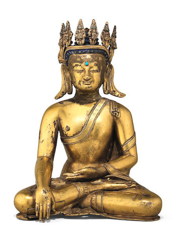 A rare gilt copper-alloy figure of crowned Buddha Tibet, 15th century
