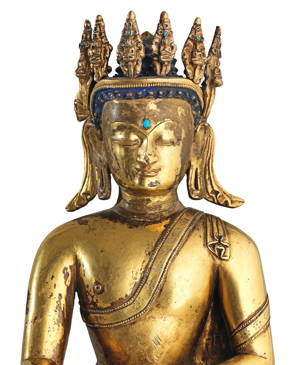 A rare gilt copper-alloy figure of crowned Buddha Tibet, 15th century