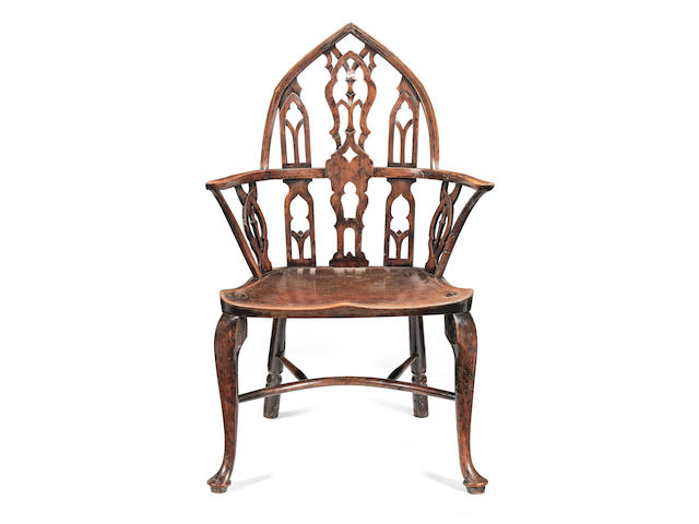 A 18th century yew and elm Gothic Windsor armchair