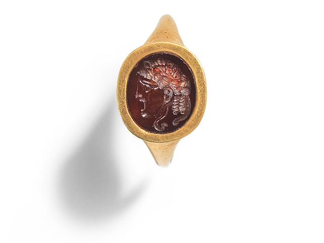 A Roman gold ring with garnet theatre mask intaglio