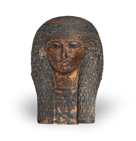 An Egyptian polychrome painted cartonnage mummy mask