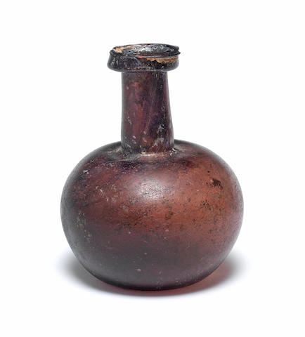 A Roman aubergine glass flask