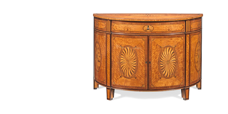 An Irish George III satinwood, sycamore, kingwood, tulipwood, purplewood and marquetry demi-lune commode in the manner of William Moore of Dublin
