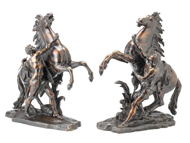 After Guillaume Coustou the elder, French (1677-1746): A large pair of late 19th century / early 20th century patinated bronze models of the Marly horses