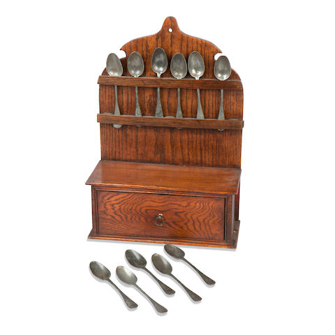 A collection of twelve pewter spoons and oak spoon rack (13)