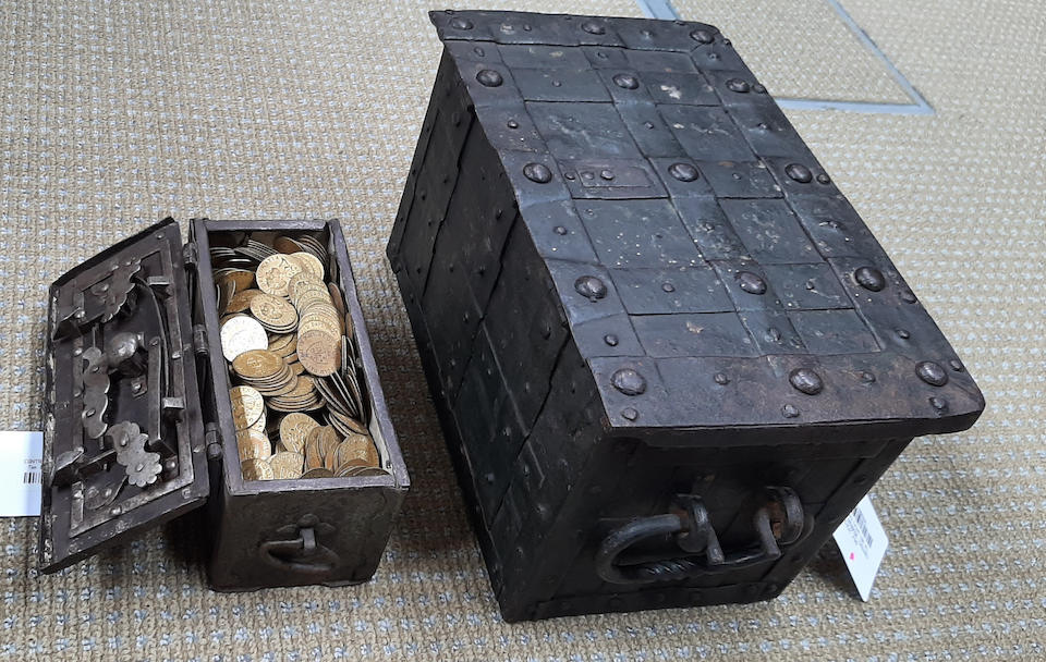 Two 18th century iron strongboxes together with a large number of Victorian brass gaming counters  (Qty)