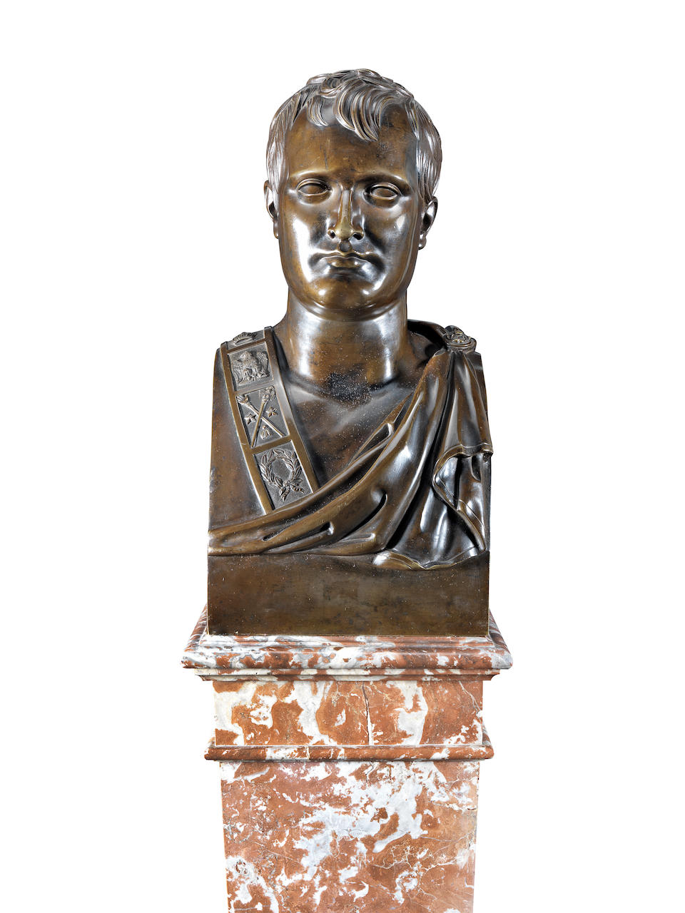 After Antoine-Denis Chaudet (1763-1810): A first half 19th century bronze bust of Napoleon together with a later veined rouge marble pedestal The bust cast after 1812, the pedestal, probably late 19th / early 20th century  (2)