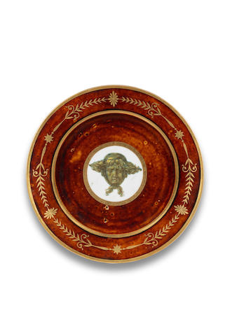 A S&#232;vres tortoiseshell-ground plate with mask of Apollo, circa 1803-05