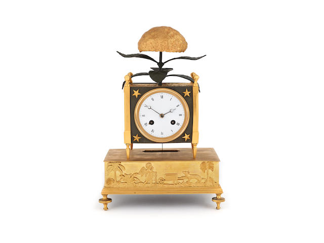 PENDULE D'EPOQUE EMPIRE A 'L'HORTENSIA' EN BRONZE DORE ET BRONZE PATINE A fine early 19th century ormolu and patinated bronze mantel clock depicting a flower 'a l'hortensia'