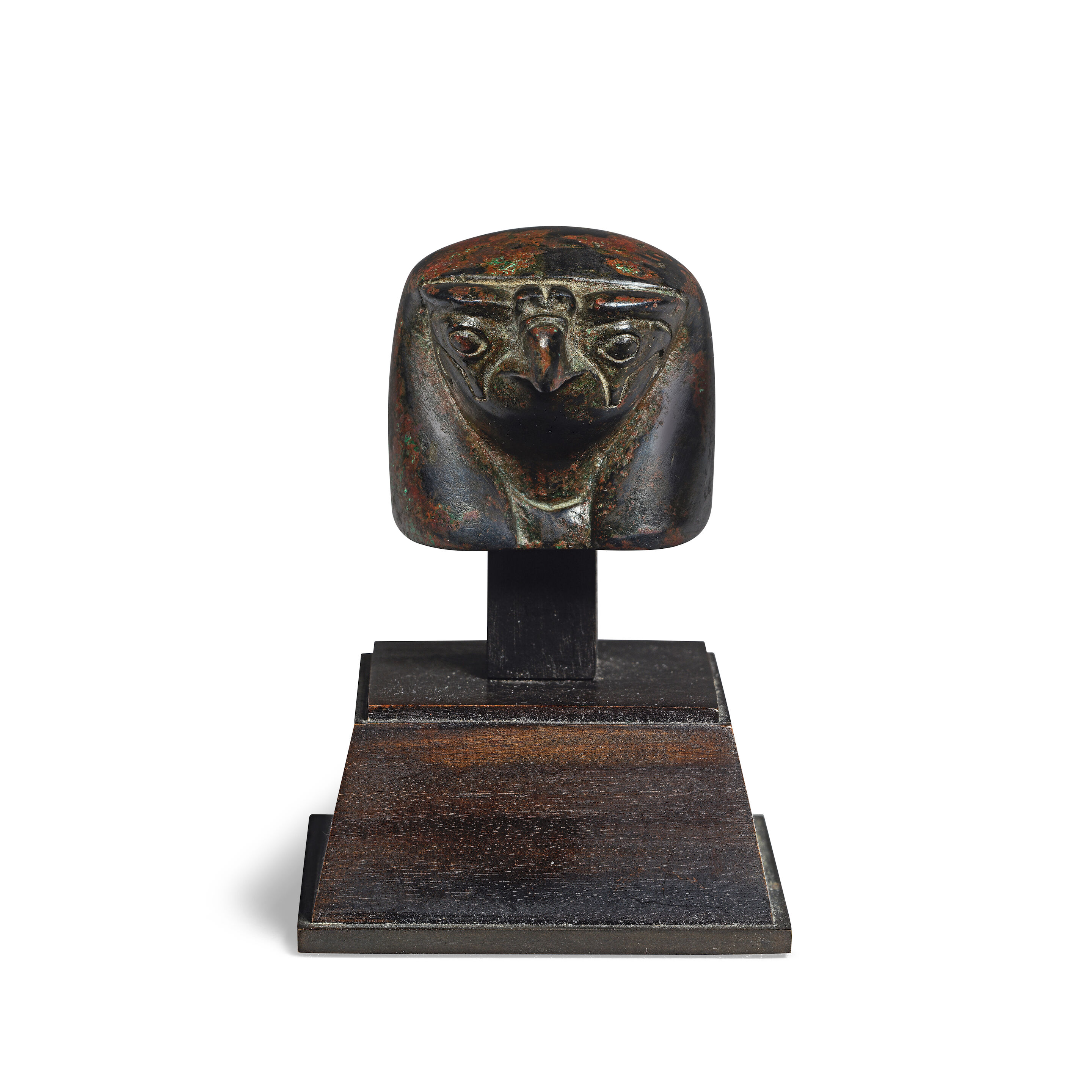 An Egyptian bronze finial in the form of a falcon