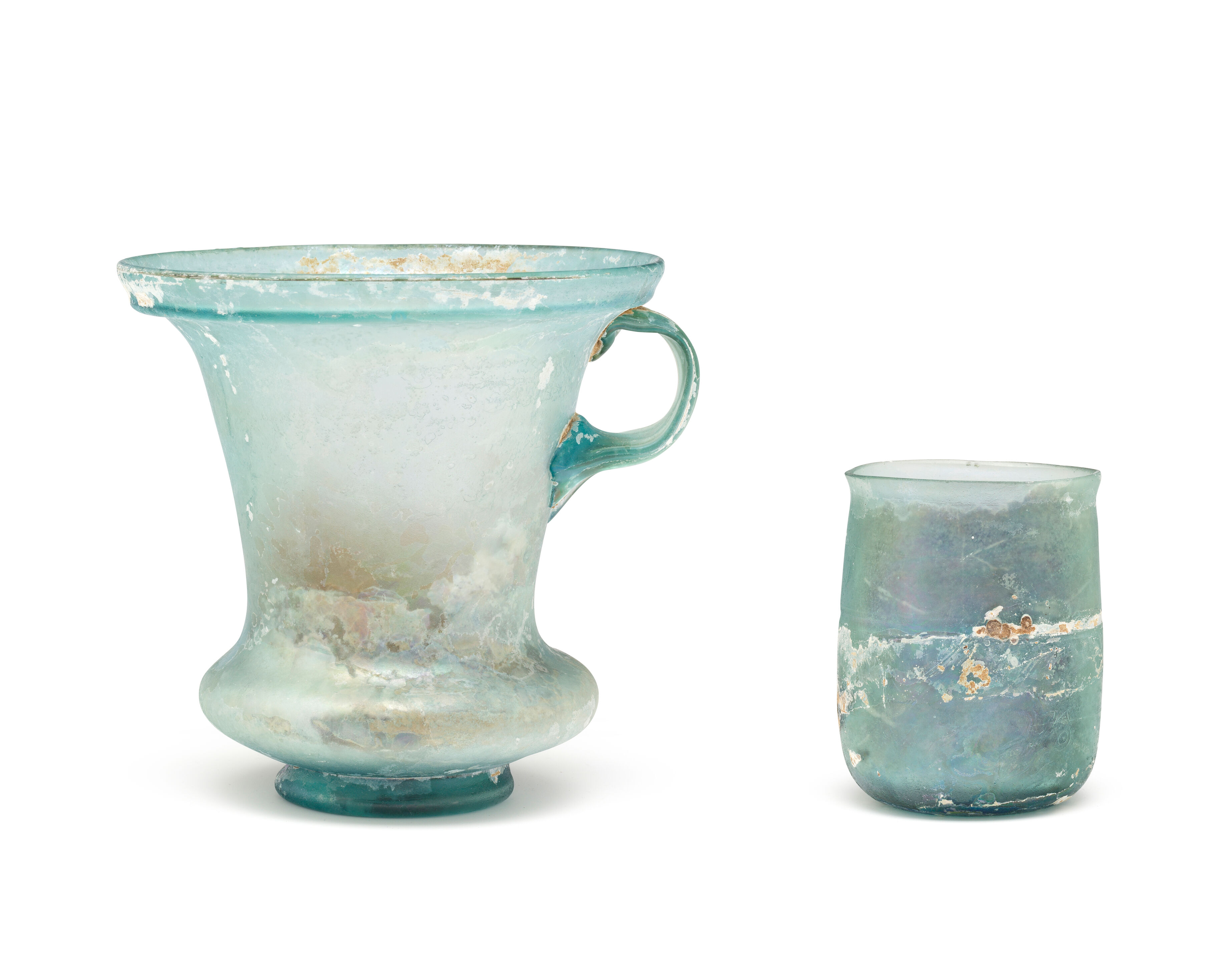 A Roman aquamarine glass modiolus and a Roman greenish-blue glass beaker 2