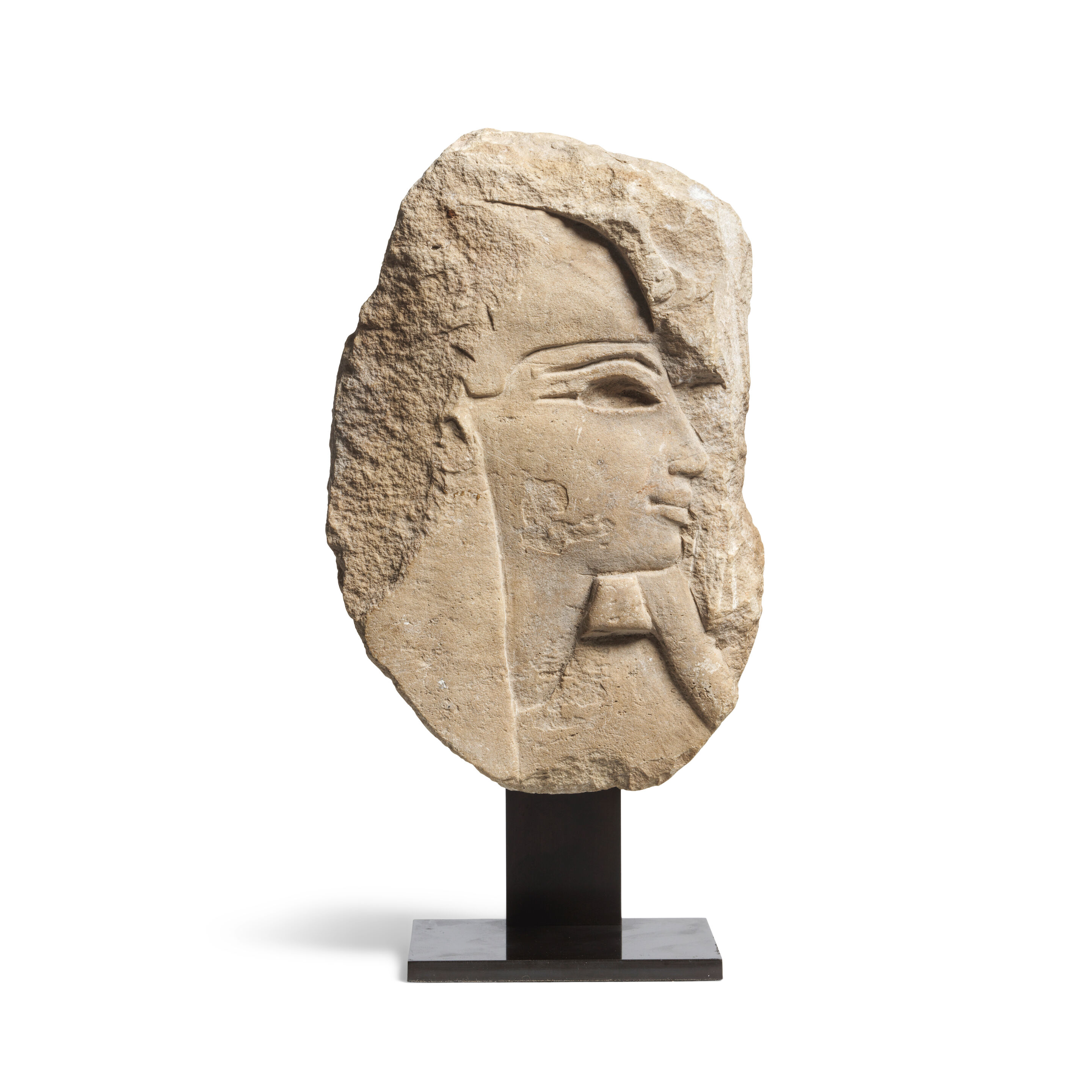 An Egyptian limestone relief of a male head in profile