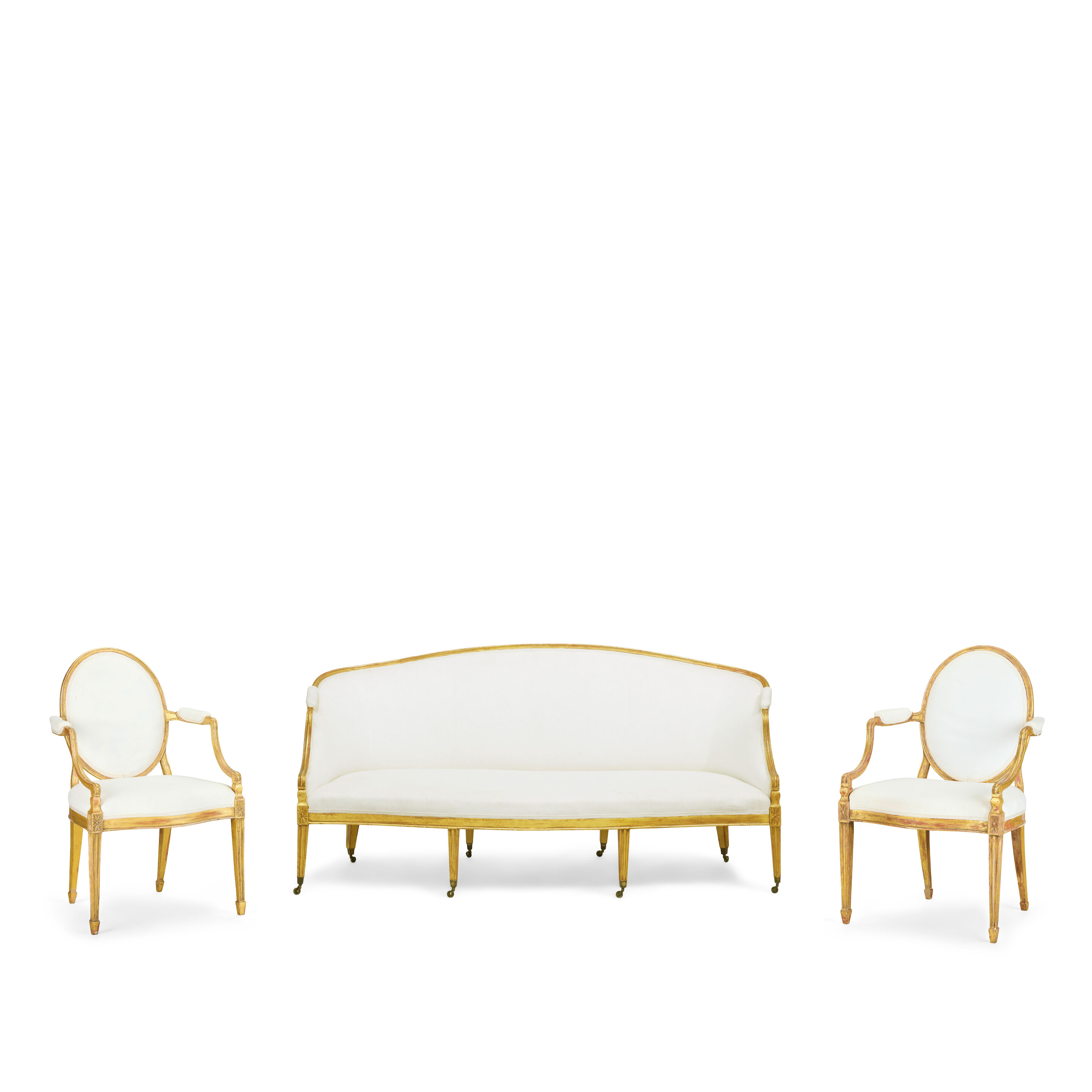 The Myrton Castle Suite: A George III carved giltwood suite to include a pair of sofas and a pair of armchairs In the manner of John Linnell (1729–1796)