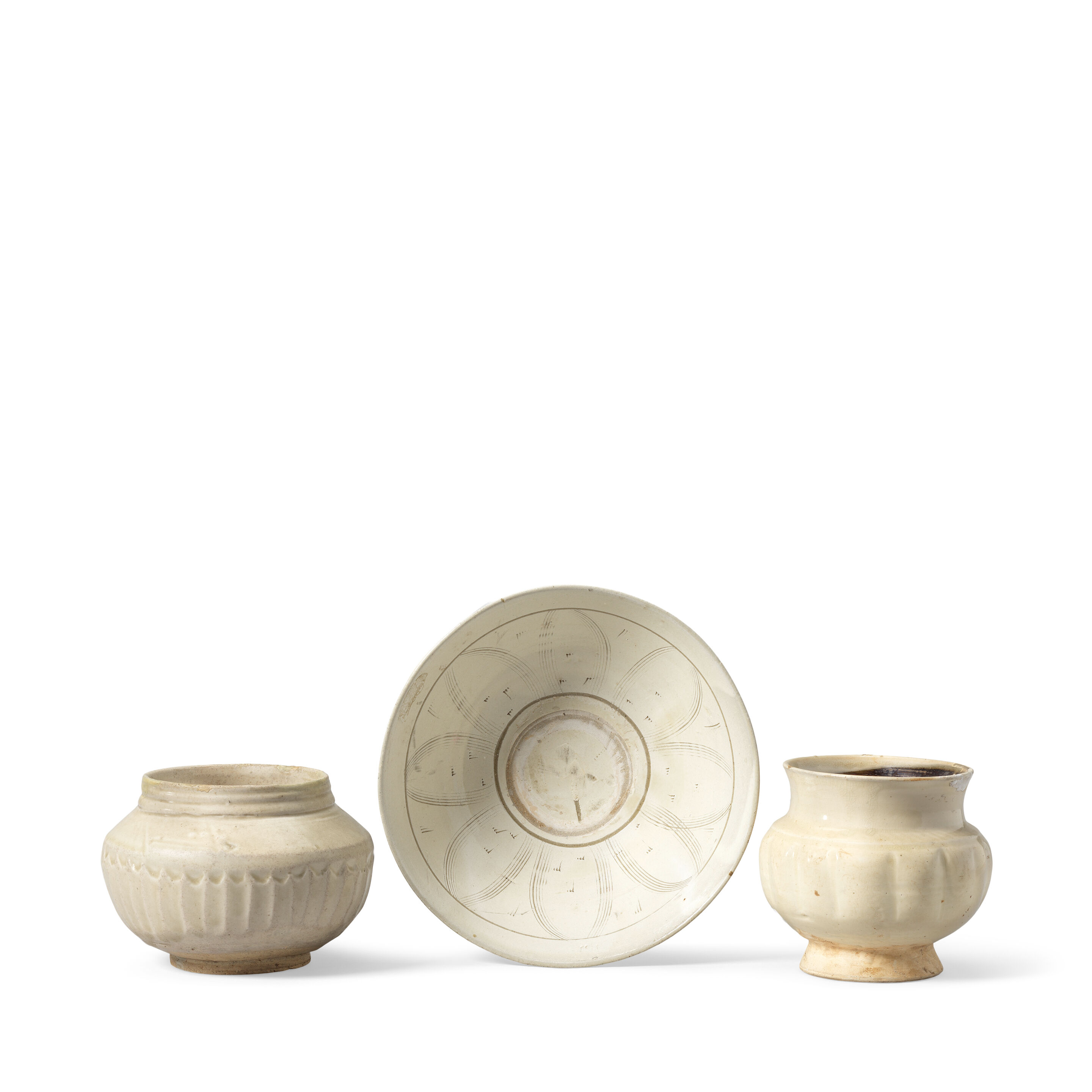 A CIZHOU-TYPE BOWL, A CREAM-GLAZED JAR AND A GREYISH-GLAZED JAR 11th to 14th century