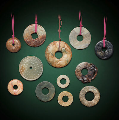 A GROUP OF TWELVE JADE BI DISCS Probably Ming Dynasty and later (12)