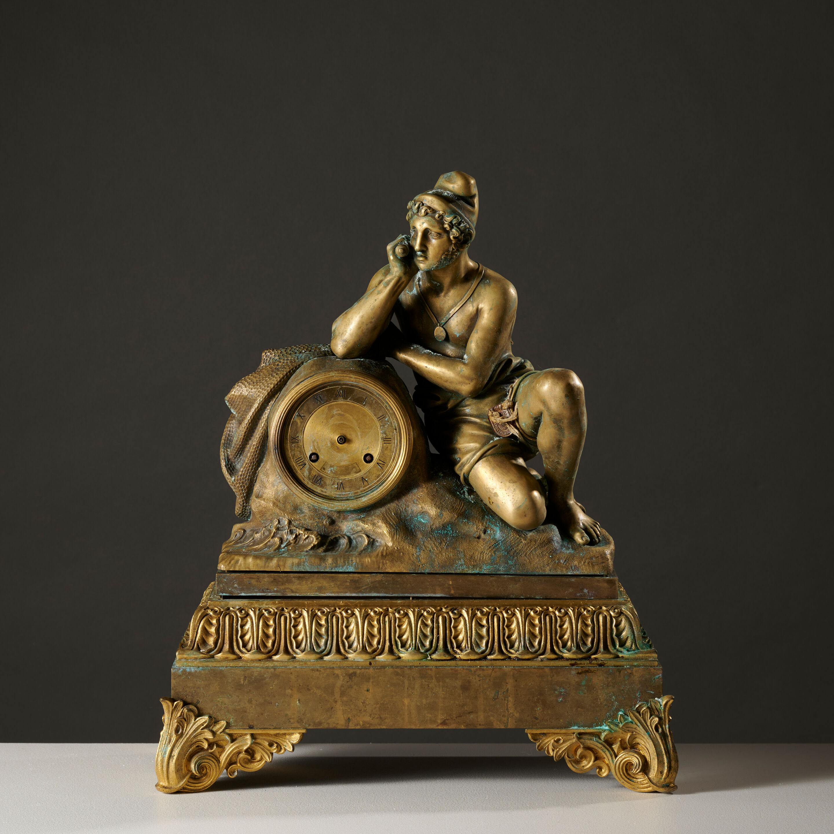 Pendule en bronze figurant un pêcheur napolitain vers 1840 A gilt-bronze mantel clock depicting a Neapolitan fisherman circa 1840