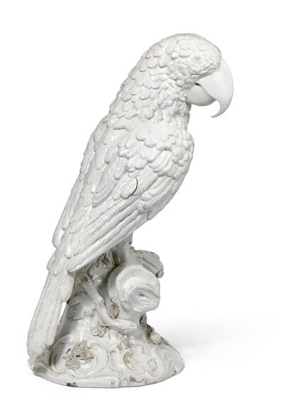 A large white glazed porcelain parrot modelled seated on wooden stump. Germany, mid-18th century. H. 60 cm.
