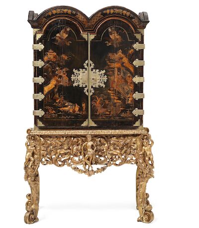 A Queen Anne black japanned cabinet on silvered stand. England, c. 1720. H. 198 cm. W. 120 cm. D. 62 cm.