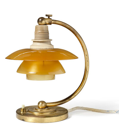 Poul Henningsen: "PH-2/1 Bedside Table Lamp". Patinated brass frame. White bakelite socket house. "PH-2/1 Bedside Table Lamp". Patinated brass frame. White bakelite socket house. Shade fitting marked "Patented" and "PH-1". Amber coloured glass shades. Manufactured approx. 1940s by Louis Poulsen. H.