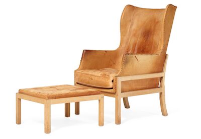 Mogens Koch: Wingback chair with matching footstool with oak frame. Upholstered with patinated natural leather fitted with leather-covered nails. (2) Wingback chair with matching footstool with oak frame. Upholstered with patinated natural leather fitted with leather-covered nails. Designed 1936. Ma
